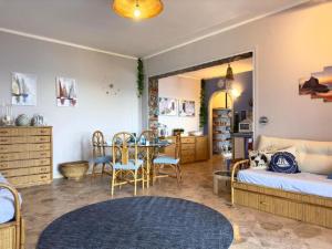 a bedroom with a bed and a table and chairs at Sicily Sea Villa Capo Zafferano in Santa Flavia