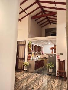 a large kitchen with a counter with plants in it at Villa Nuelumalee UpStairs in Hikkaduwa