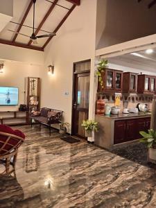a large living room with a kitchen and a couch at Villa Nuelumalee UpStairs in Hikkaduwa