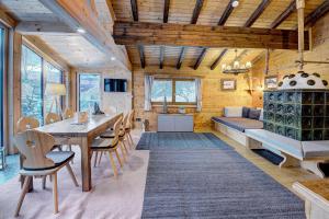 a dining room and living room with a table and chairs at Ferienhaus Gasteg in Maria Alm am Steinernen Meer