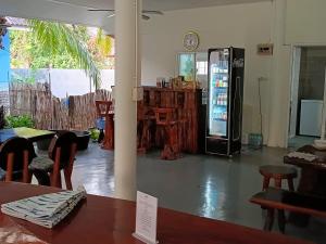 a soda machine in a room with a table and chairs at Happy Mind Resort in Sam Roi Yot