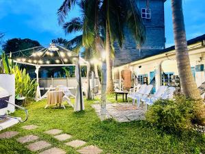 a patio with a table and chairs under a tent at Dar Yasmine in Pantai Cenang