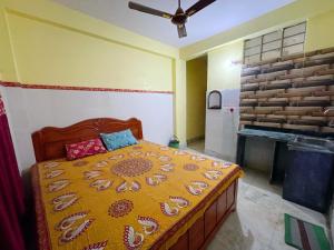 a bedroom with a bed in a room with a fireplace at Narasimha Dev Guest House in mayapur