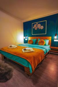 a bedroom with a large bed with two towels on it at F A N BunGALow Vama Buzăului in Vama Buzăului