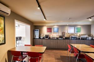 a restaurant with tables and chairs and a counter at Comfort Inn in Rouyn-Noranda