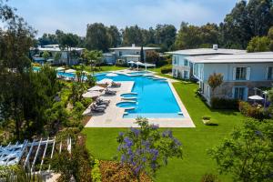 an overhead view of a pool with chairs and umbrellas at Azure Villas By Cornelia in Belek