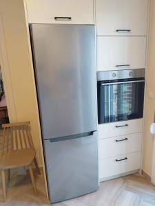 a stainless steel refrigerator in a kitchen next to a stove at Villa Kalliope in Nénita +14 photos