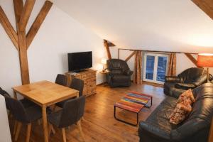 a living room with a couch and a table at Spreewald Spreemilia Gurkenbude in Lübbenau