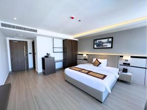 a bedroom with a large white bed in a room at LN Hotel & Residence in Phnom Penh