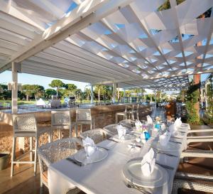 a restaurant with white tables and chairs with a view at Azure Villas By Cornelia in Belek