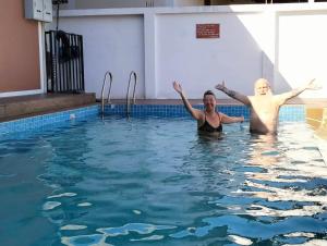 a man and a woman in a swimming pool at River Bend Villas in Mae Rim +15 photos