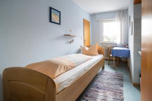 a bedroom with a bed with a table and a window at Gasthaus Krone in Pforzheim