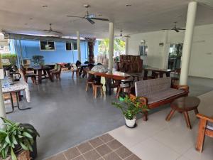 a living room with tables and chairs and tablesktop at Happy Mind Resort in Sam Roi Yot