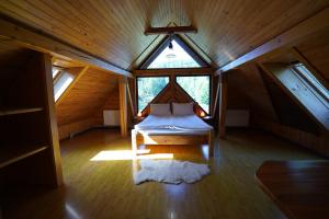 a bedroom with a bed in a room with a window at Hotel Ozero Vita in Nizhniy Studenyy