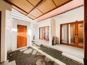 a room with wooden doors and windows in a building at Cannella Suites Ubud - Ubud Center prime location in Ubud +34 photos