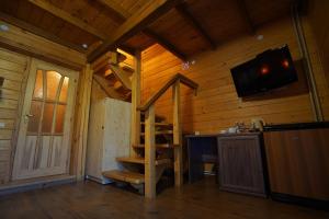 a room with a staircase in a log cabin at Hotel Ozero Vita in Nizhniy Studenyy +270 photos