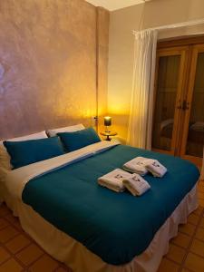 a bedroom with a large bed with towels on it at Gilardi Apartments in Cusano Mutri