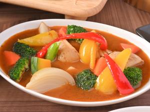 a bowl of soup with vegetables and meat in it at Hotel Abest Sapporo in Sapporo