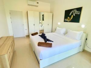 a bedroom with a large white bed with towels on it at Thala Villa Koh Samui in Nathon Bay +10 photos