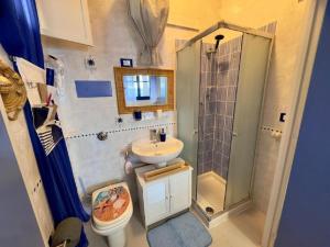 a small bathroom with a sink and a shower at Sicily Sea Villa Capo Zafferano in Santa Flavia +32 photos