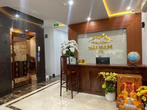 a hotel lobby with a reception desk and a bar at Hải Nam Hotel Tây Ninh in Tây Ninh