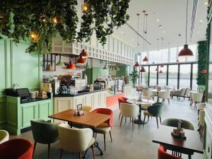a restaurant with tables and chairs in a room at Modern 1BR Yas Island Pool, Gym, Parking in Abu Dhabi