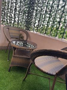 two chairs and a table in front of a window at TMT Homes in Nairobi