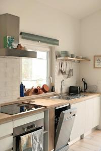 a kitchen with a sink and a counter top at Casa Verde Oliva - WelcHome in Rocca San Giovanni
