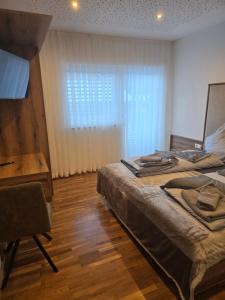 a bedroom with two beds and a desk and a window at Haus Levi in Imst