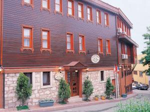 a large wooden building on the corner of a street at Tashkonak Studio Suites in Istanbul