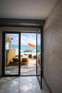 an open door to a patio with a view of the beach at Noahs Ark Beachfront in Lamai
