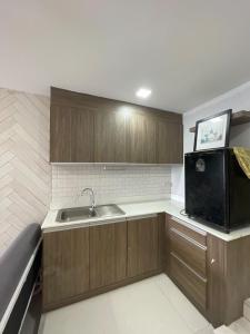 a kitchen with wooden cabinets and a sink at Noahs Ark Beachfront in Lamai +20 photos