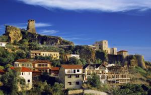 a group of houses on a hill with a castle at Kruja Luxury Suites in Krujë