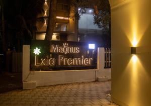 a sign for alexius lexico premier on a building at night at Magnus Lxia Premier, Kalyani Nagar Pune in Pune