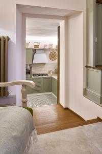 a kitchen with green cabinets and a table in a room at Casa Vicky in Città di Castello