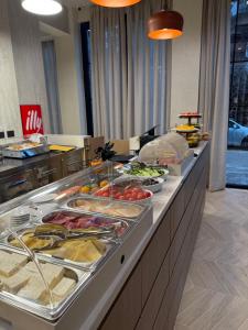 a buffet line with many different types of food at Post Inn Hotel-New Bazaar in Tirana