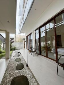 a hallway of a house with rocks on the floor at Ramady Guest House in Tumbak Bayuh