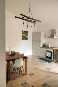 a kitchen with a wooden table and a wooden floor at Casa Verde Oliva - WelcHome in Rocca San Giovanni