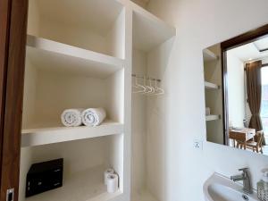 a bathroom with a sink and a mirror at Ramady Guest House in Tumbak Bayuh +41 photos