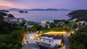 a town with a view of a lake at night at Yeosu falling in blue ocean view pension in Yeosu