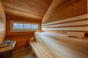 a sauna with wooden walls and a window at Lüftenblick - 2 Ferienwohnungen am Starnberger See, mit Terrasse oder Balkon, Weitblick, Sauna, Kamin, E-Ladestation in Berg am Starnberger See +63 photos