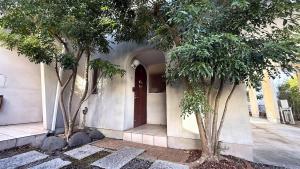 a house with two trees in front of a door at kamakura retreatB in Kamakura