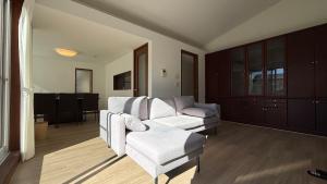 a living room with a couch and a chair at kamakura retreatB in Kamakura
