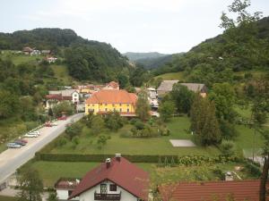 a view of a village with a house and a road at Guest House Čater in Laško