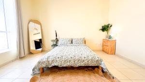 a bedroom with a bed and a large mirror at Spacious 2BR Apartment,3 Bathrooms, Near Mall in Abu Dhabi