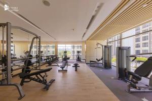 a gym with a lot of treadmills and machines at M2 Homestay vinhomes ocean in Gia Lâm Pho