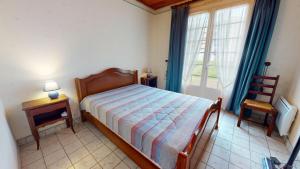a bedroom with a bed and a chair and a window at Villa des Oceanides in Saint-Gilles-Croix-de-Vie +22 photos
