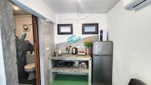 a small kitchen with a sink and a refrigerator at Feel home Private Studio in Ko Phangan