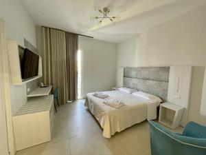 a hotel room with a bed and a television at Hotel da ettore in Porto Cesareo