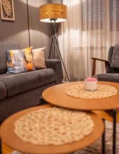 a living room with two tables and a couch at Modern Mountain - Comfort Apartment in Kolašin +29 photos
